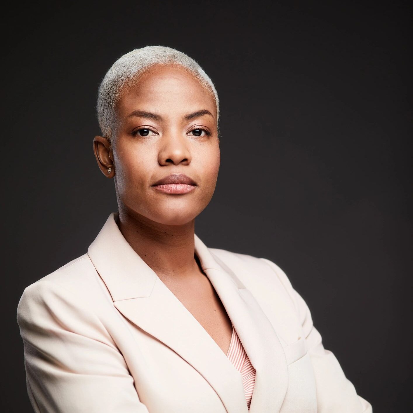 Young African American businesswoman portrait with arms crossed over chest.